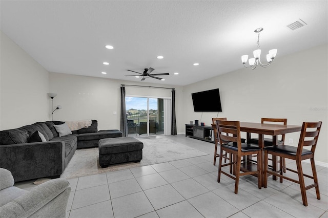 living area with recessed lighting, visible vents, baseboards, ceiling fan with notable chandelier, and light tile patterned flooring