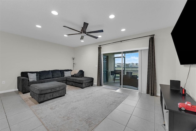 living room featuring recessed lighting, light tile patterned flooring, ceiling fan, and baseboards