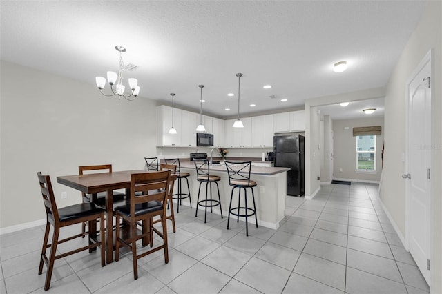 dining area with light tile patterned floors, baseboards, a notable chandelier, and recessed lighting