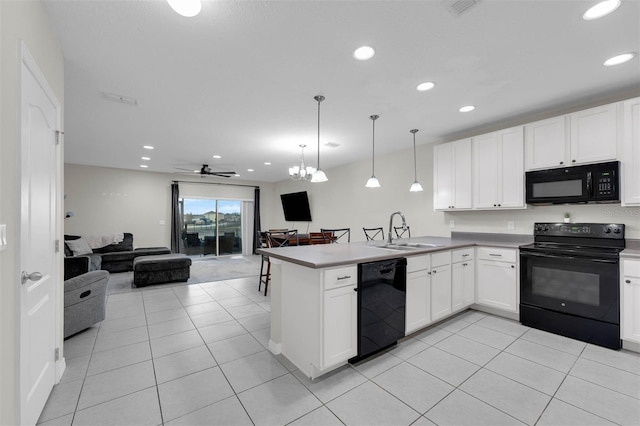 kitchen with open floor plan, a peninsula, black appliances, white cabinetry, and pendant lighting