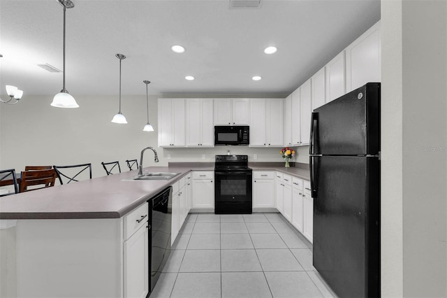 kitchen featuring hanging light fixtures, white cabinetry, a sink, a peninsula, and black appliances