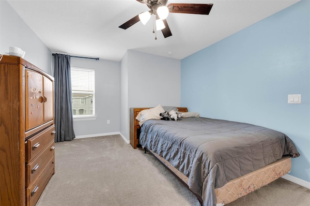 bedroom featuring baseboards, ceiling fan, and light colored carpet