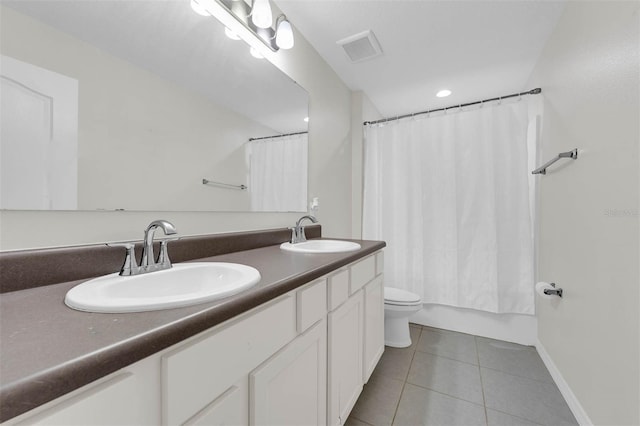 bathroom featuring shower / bath combination with curtain, visible vents, a sink, and tile patterned floors