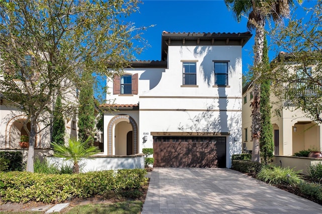 mediterranean / spanish house with a garage