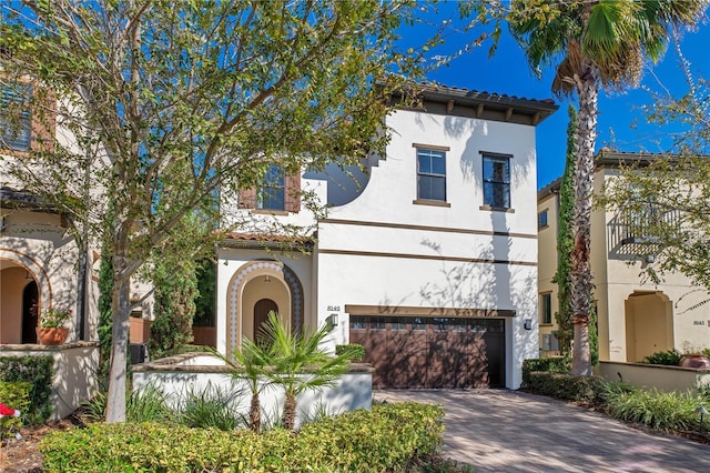 mediterranean / spanish-style home with a garage