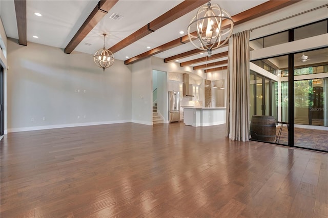 unfurnished living room with beam ceiling, a chandelier, and dark hardwood / wood-style floors