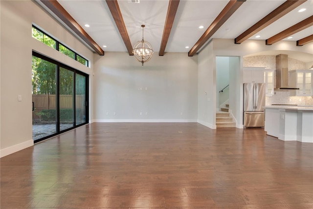 unfurnished living room featuring a notable chandelier, beam ceiling, and dark hardwood / wood-style floors