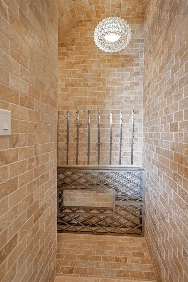 bathroom featuring brick wall