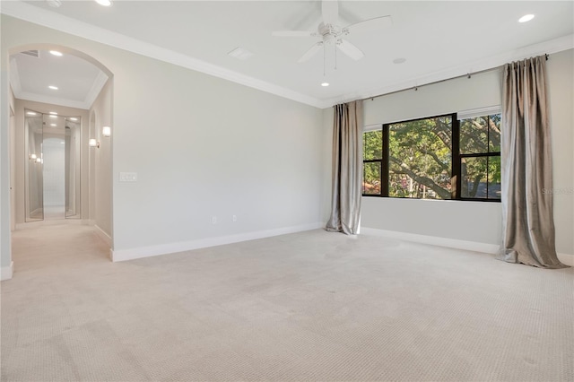 carpeted empty room featuring ceiling fan and ornamental molding