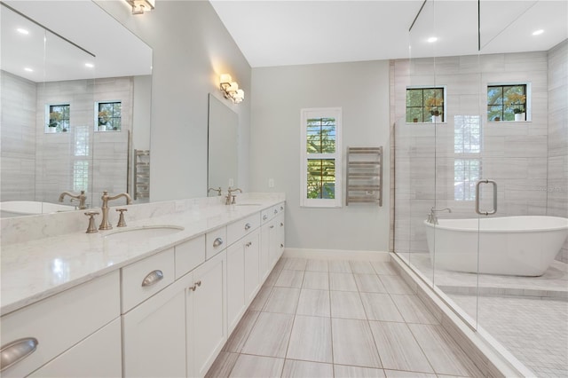 bathroom featuring plus walk in shower, tile patterned flooring, radiator, and vanity