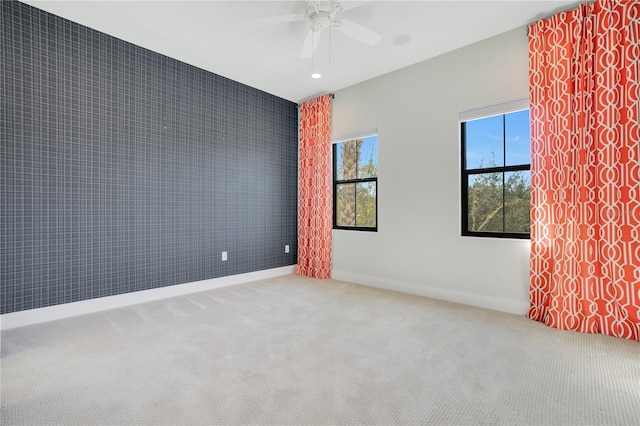 unfurnished room with carpet floors and ceiling fan