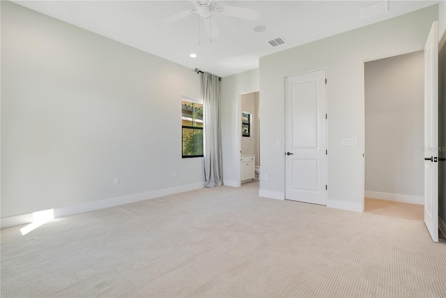 unfurnished bedroom with light colored carpet and ceiling fan