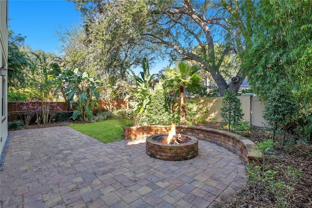 view of patio / terrace featuring an outdoor fire pit