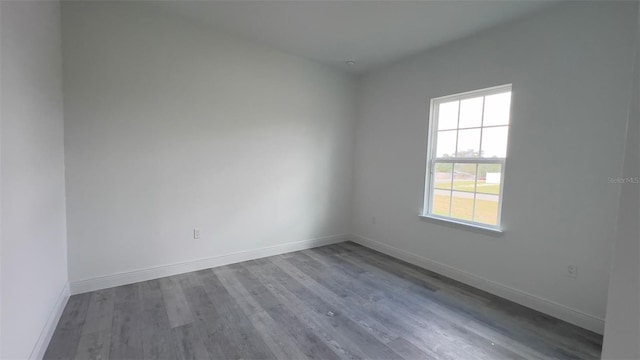 unfurnished room with wood-type flooring