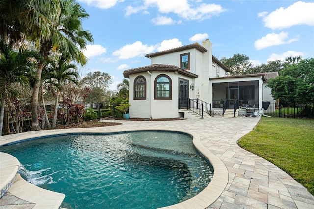 view of pool with a fenced in pool, a lawn, a fenced backyard, a sunroom, and a patio