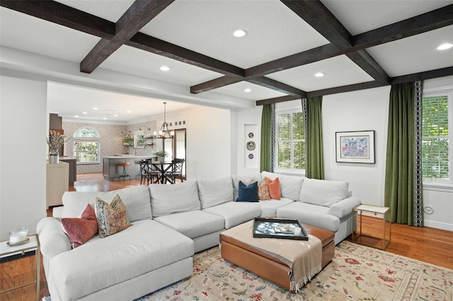 living room featuring plenty of natural light, wood finished floors, and coffered ceiling