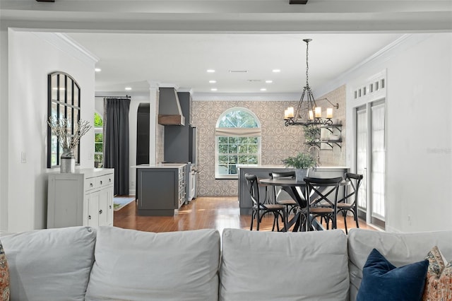 living room featuring wallpapered walls, crown molding, baseboards, recessed lighting, and wood finished floors