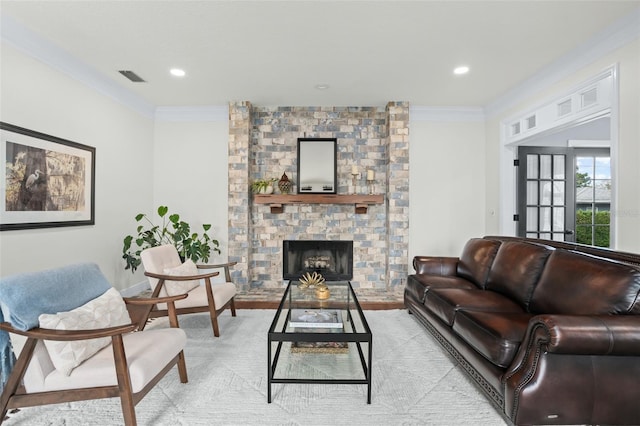 living area featuring visible vents, recessed lighting, a brick fireplace, and crown molding