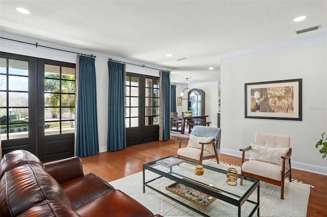 living room featuring visible vents, wood finished floors, recessed lighting, french doors, and baseboards