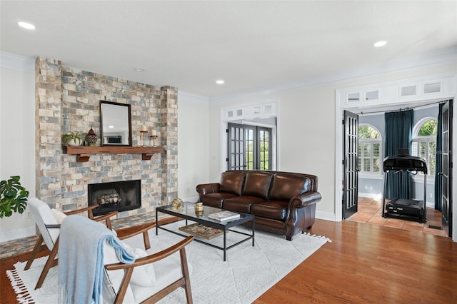 living area featuring plenty of natural light, french doors, and ornamental molding