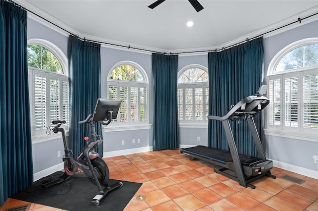 workout room with light tile patterned floors, a ceiling fan, baseboards, visible vents, and ornamental molding