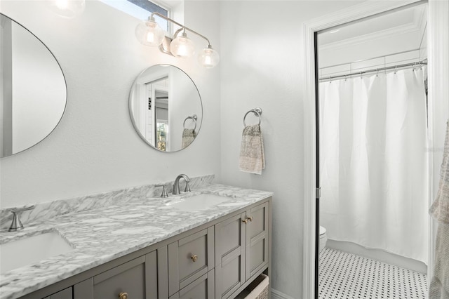 full bath featuring a sink, toilet, and double vanity