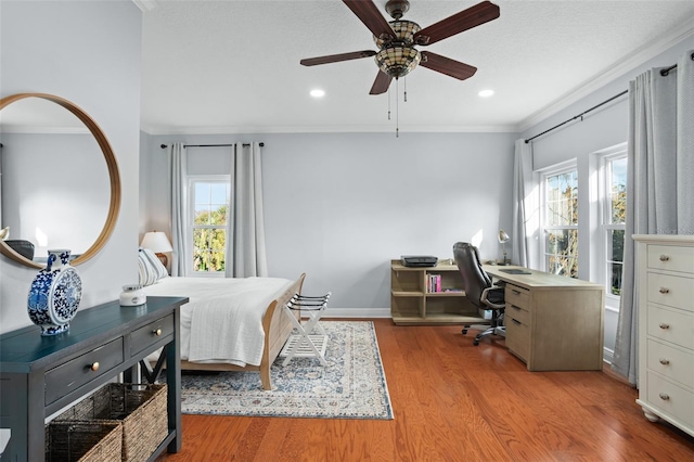 bedroom with crown molding, ceiling fan, baseboards, recessed lighting, and wood finished floors