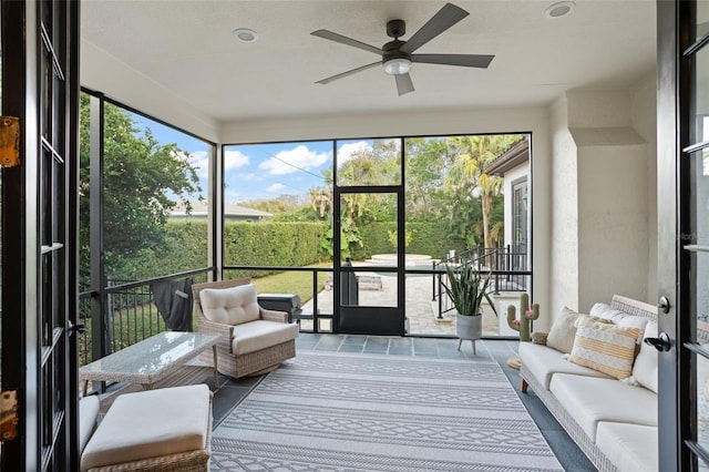 sunroom with plenty of natural light and a ceiling fan