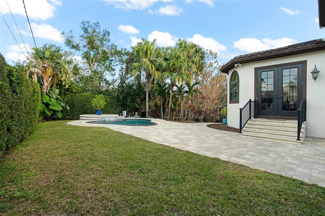 view of yard with a fenced backyard, a fenced in pool, french doors, and a patio