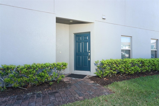 entrance to property with stucco siding