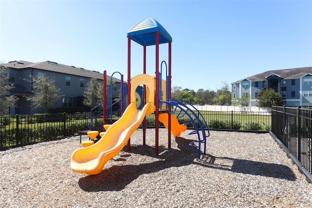 community playground featuring a residential view and fence