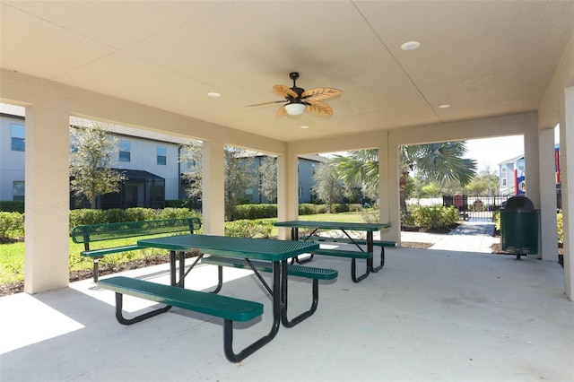 view of property's community featuring a patio, outdoor dining area, and fence