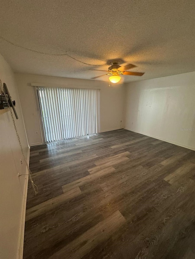5951 Village Cir Unit Ge, Orlando, FL 32822 - spare room with a textured ceiling, ceiling fan, and dark wood-type flooring