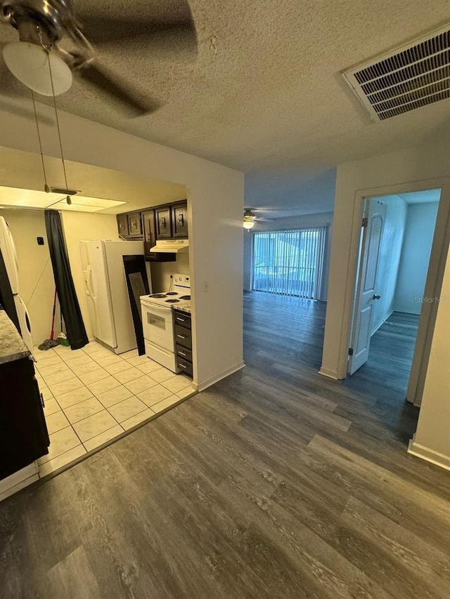 5951 Village Cir Unit Ge, Orlando, FL 32822 - kitchen featuring white appliances, visible vents, light countertops, and a ceiling fan