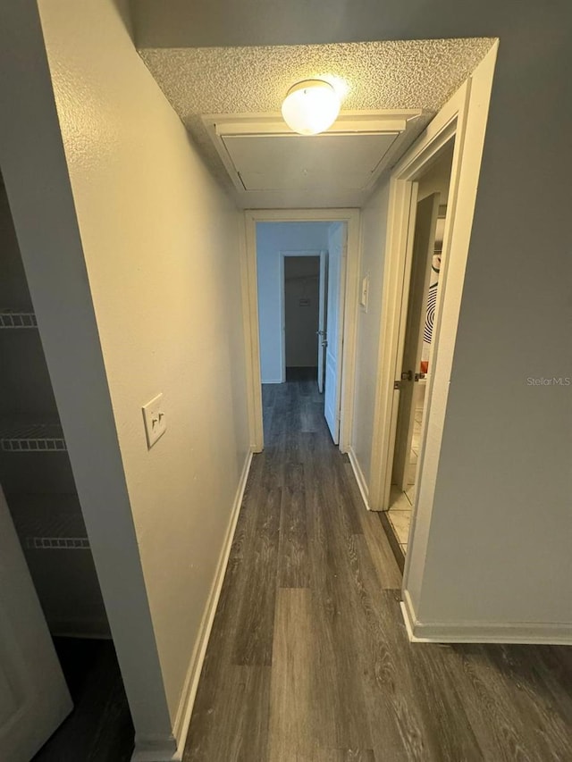 5951 Village Cir Unit Ge, Orlando, FL 32822 - corridor with attic access, dark wood-style flooring, and baseboards