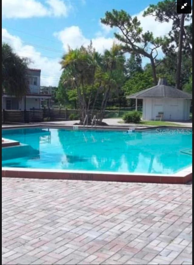 5951 Village Cir Unit Ge, Orlando, FL 32822 - community pool featuring a patio area and fence