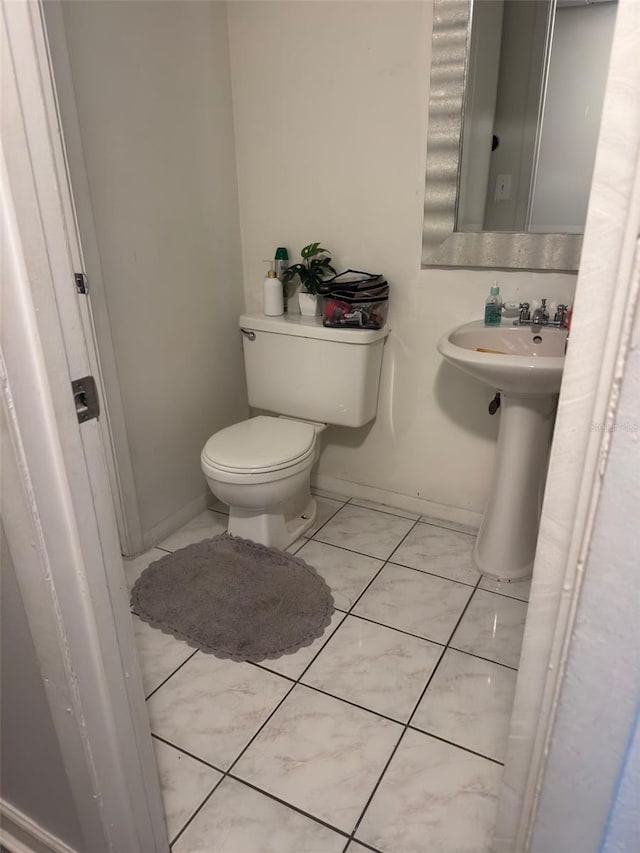 5951 Village Cir Unit Ge, Orlando, FL 32822 - half bathroom with toilet, baseboards, and tile patterned floors