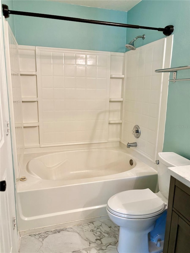 bathroom featuring toilet, marble finish floor, washtub / shower combination, and vanity