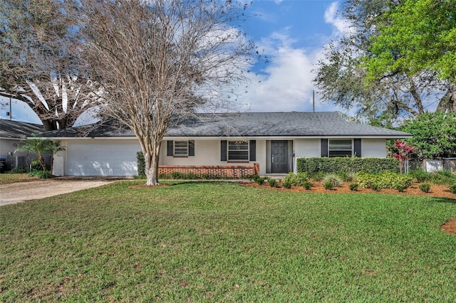 ranch-style house with a front yard, concrete driveway, brick siding, and an attached garage