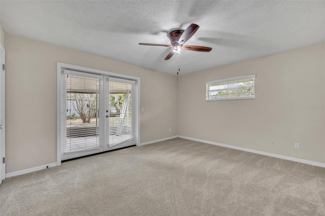 empty room featuring light carpet, baseboards, a wealth of natural light, and french doors