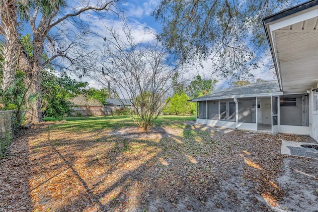 view of yard featuring a sunroom and a fenced backyard