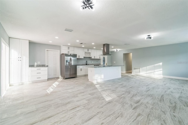 kitchen featuring island exhaust hood, sink, white cabinetry, and stainless steel refrigerator with ice dispenser