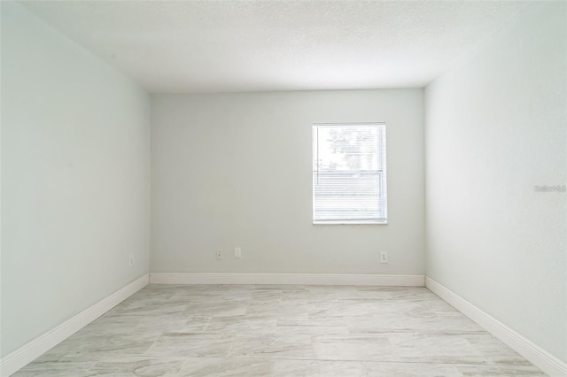 spare room featuring a textured ceiling