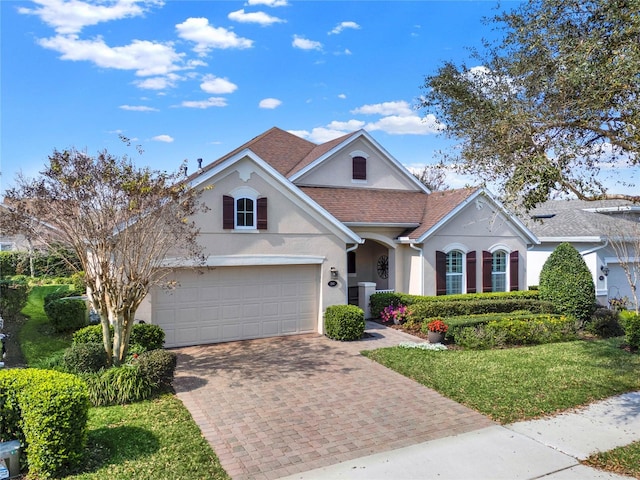 view of front of property with a garage, cooling unit, and a front lawn