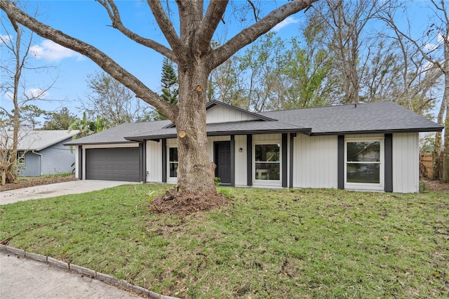 ranch-style home featuring a garage and a front yard