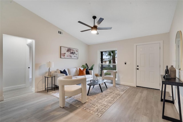 living room with light wood-type flooring, lofted ceiling, and ceiling fan