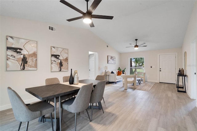 dining area with light wood-type flooring, vaulted ceiling, and ceiling fan