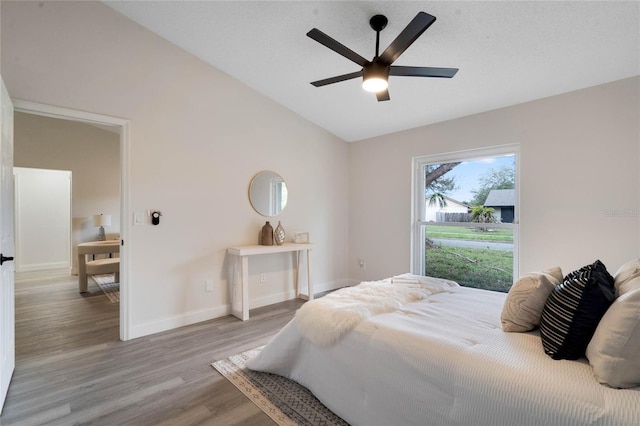 bedroom featuring ceiling fan, light hardwood / wood-style flooring, and vaulted ceiling