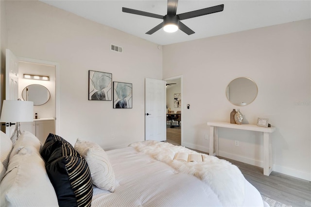 bedroom featuring ceiling fan, wood-type flooring, and lofted ceiling