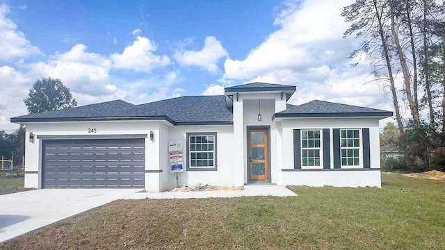 prairie-style home with a front lawn and a garage